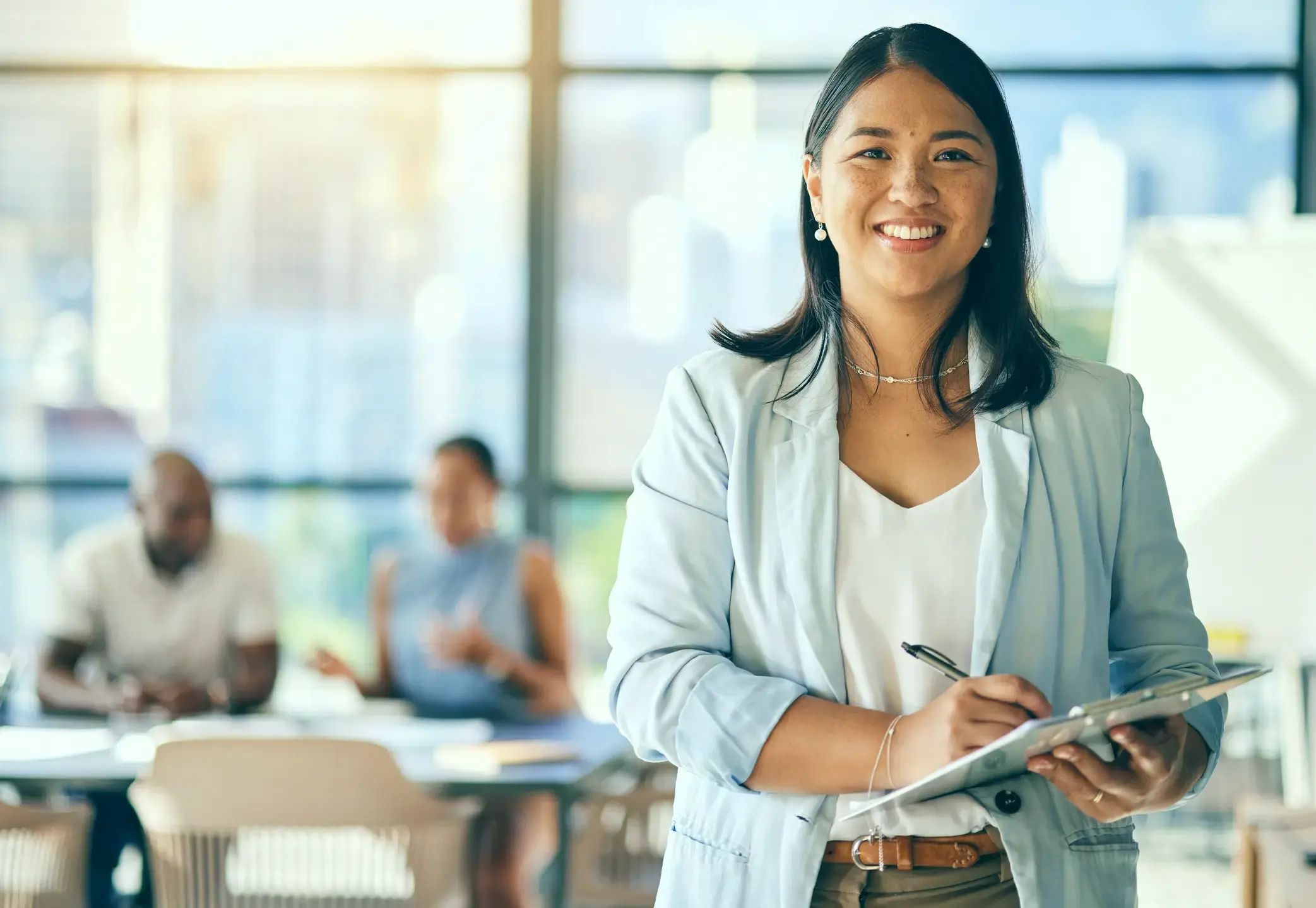 Smiling businesswoman taking notes after a meeting.